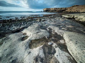 Bright polished stones at low tide on a coastal landscape