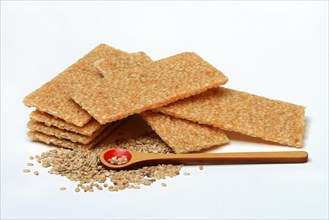 Sesame bar and sesame seeds with wooden spoon
