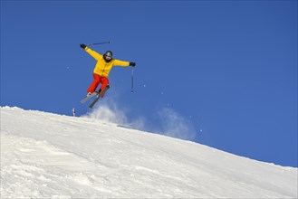 Skiers jumping on the ski slope