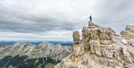 Mountaineer stands on a rock