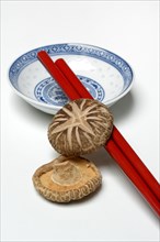 Dried shiitake mushrooms with bowl and chopsticks