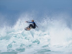 Surfer on surfboard on foam crown of a wave