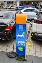 Electric cars fill up with green electricity at a charging station