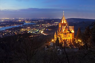 Illuminated Drachenburg Castle above the Rhine Valley in the evening