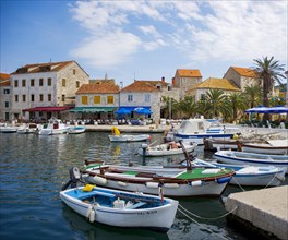 Promenade with fishing boats in the port