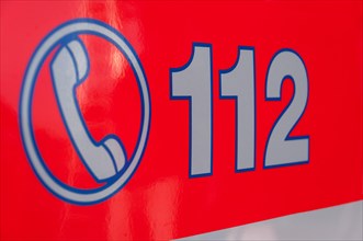 Inscription of the emergency number 112 on a rescue vehicle
