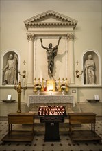 Side altar with burning sacrificial candles