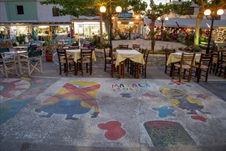 Colorful painted streets between shops and restaurants in the evening in Matala