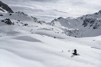 Ski tourers cross a flat slope