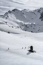Ski tourers cross a flat slope