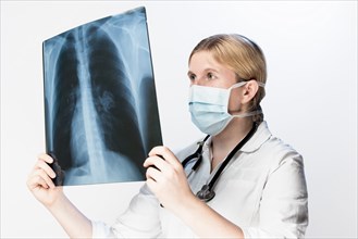 Doctor looks at X-ray image