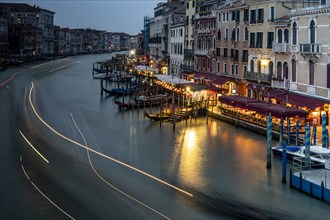 View of the Canale Grande with illuminated restaurants at night