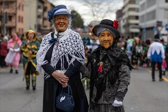 People masked as a pair of witches from Kriens at the carnival parade of the Maettli Guild in Littau