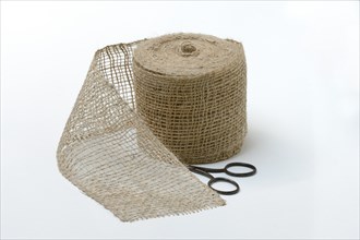 A roll of jute tape with scissors