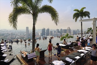 City view with tourists at the Infinity Pool of Marina Bay Sands Hotel