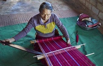 Woman weaving traditional patterns