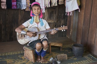 Folk group Padaung woman plays guitar and sings