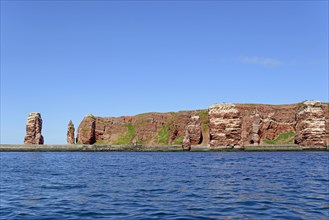 View from the water to the red sandstone rocks with Langer Anna