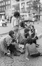 Hippies playing guitar on Dam Square