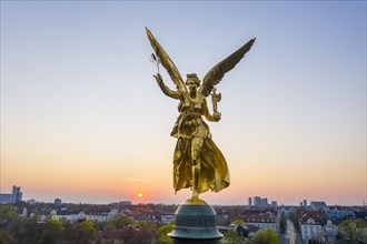 Golden angel of peace at sunrise