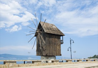 Wooden windmill and monument near historical centre of the town Nesebar