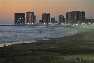 Beach Playa Cavancha and skyscrapers at dusk