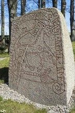 Rune stone with ship and animal figure