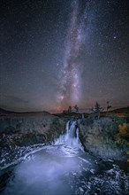 Orchon waterfall at night with starry sky and Milky Way
