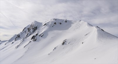 Moelser Sonnenspitze with ski tracks and summit cross