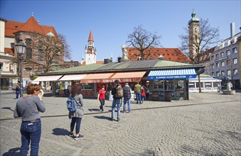 Queue of people with a safe distance in front of food stalls at Viktualienmarkt