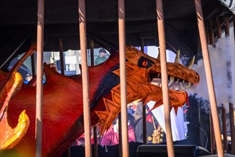 Dragon figure behind bars, Carnival procession of the Wey Guild on Rosenmontag