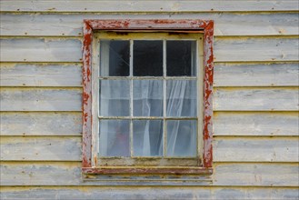 Weathered wooden facade with window, Saunders Island