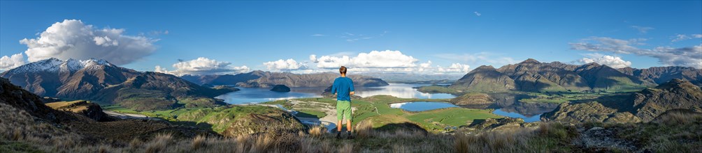 Hiker is looking out for Wanaka Lake and mountains, Rocky Peak