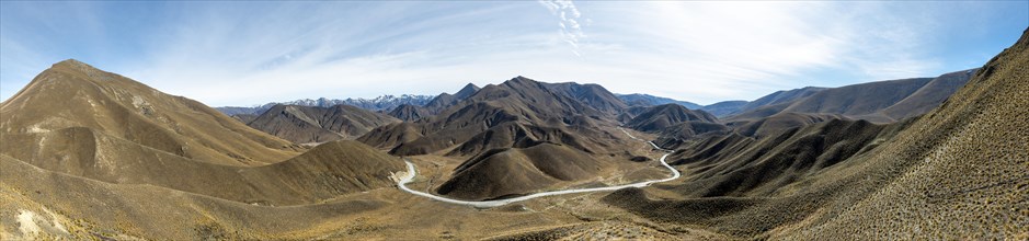 Barren mountain landscape with pass road, Lindis Pass