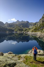 Hikers at the mountain lake, Lac d'Artouste