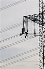 High voltage engineers working on high voltage pylons, Baden-Wuerttemberg