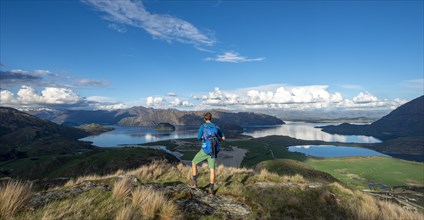 Hiker is looking out for Wanaka Lake and mountains, Rocky Peak