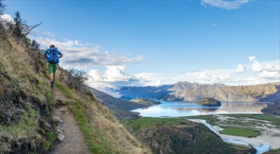 Hiker on the hiking trail to Rocky Peak, views of Wanaka Lake and mountains