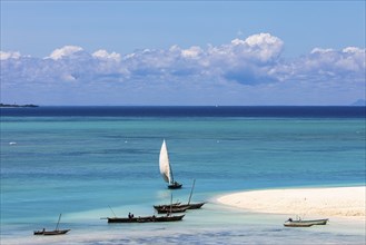 Fishing boats in turquoise green water on the beach of Kendwa, Zanzibar