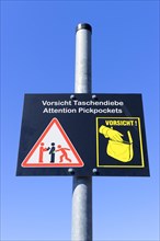 Plaque with a warning sign for pickpockets, Berlin