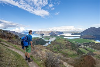 Hiker on the trail to Rocky Peak, views of Wanaka Lake and mountains