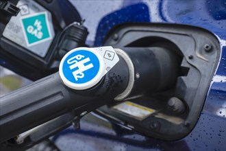 Passenger car refuels H2 hydrogen at a H2 hydrogen filling station, Herten