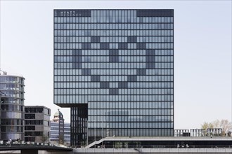 Windows form a heart on the facade of the closed Hyatt Regency Hotel, sign of solidarity during the Corona pandemic