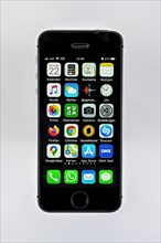 IPhone with different apps on display, cutout