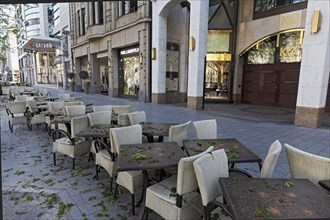 Deserted Koenigsallee, tables and chairs of a closed cafe