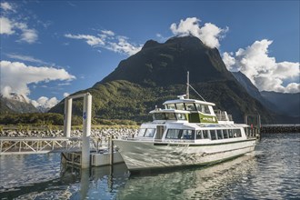 Tourist boat at the jetty in Milford Sound, Fjordland National Park