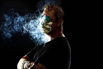 Man with face mask smoking cigarette