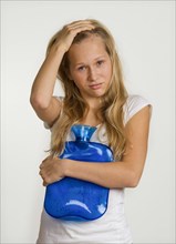 Sick girl with hot water bottle