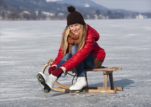 Young girl ice skating at the lake