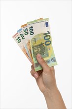 Woman holding fanned euro banknotes in her hand